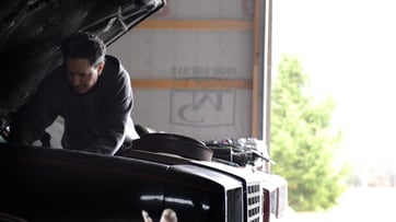 Automotive DIYer checking under the hood of a vehicle