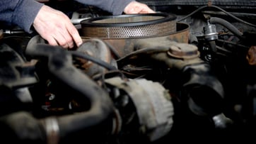 Automotive enthusiast working under the hood of a vehicle