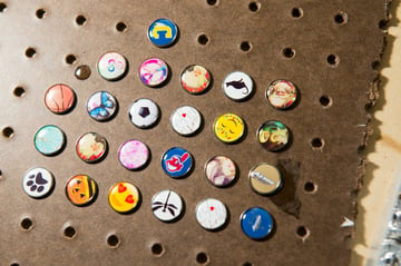 Board covered in domed resin jewelry snap buttons