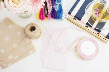 Scrapbooking and paper crafting supplies on a white table