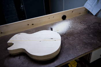 Woodworking guitar project on a workbench